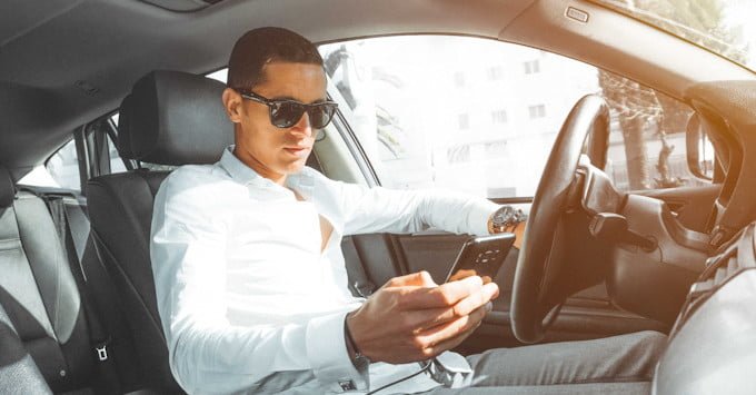 A driver checking his cell phone